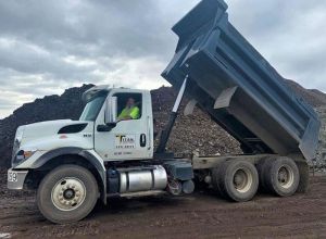 Titan dump truck with topsoil delivery