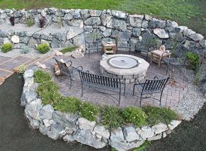 Outdoor living area with fireplace and natural stonework